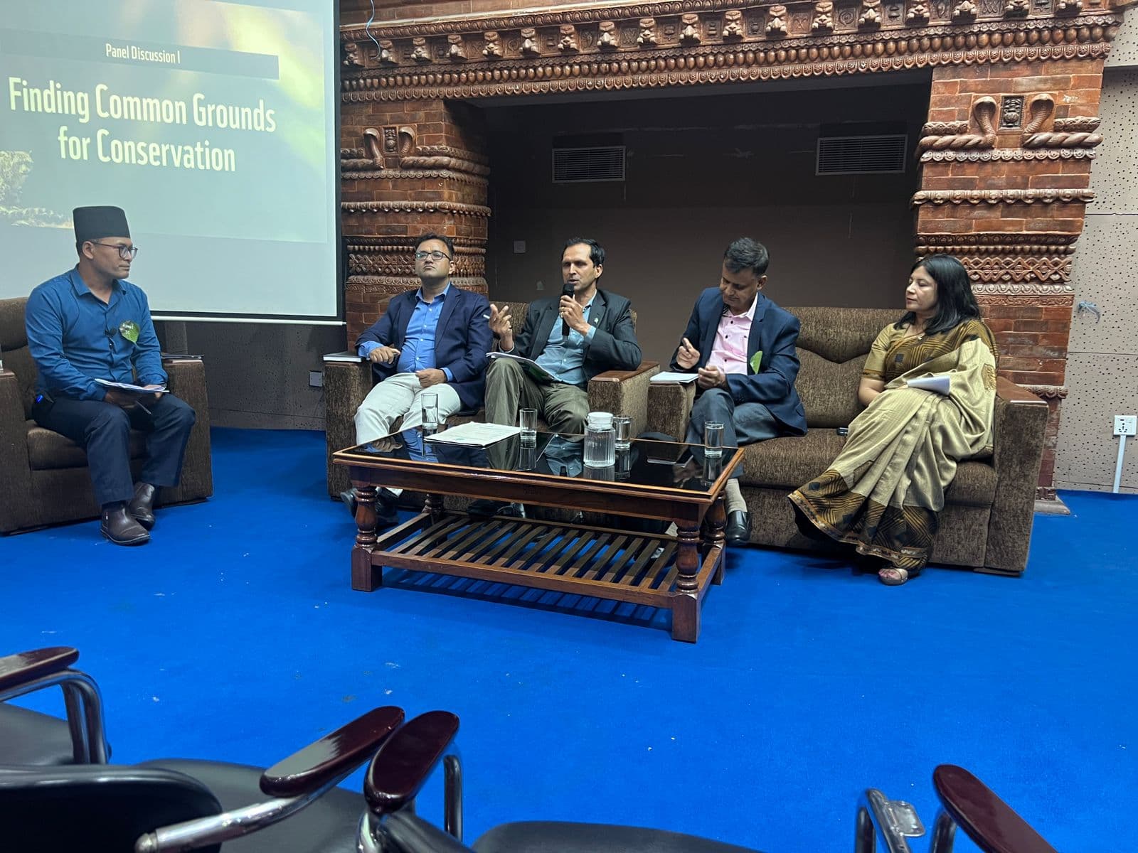Panel discussion on "Finding Common Grounds for Conservation" at a conference.